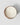 Top-down view of a round white candle in a rose gold mercury glass container with a scalloped rim, set against a light gray background with a soft shadow.