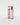 A Petra Living 'Mon Amour' travel spray perfume bottle with a metallic pink cap stands next to its pink packaging box on a clean, light gray background.