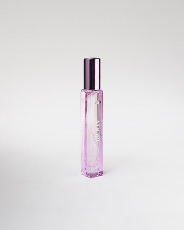 Pink bottle of perfume on white background.