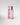 Pink perfume bottle and packaging with 'Petra Living' branding on a light gray background