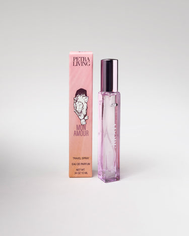 Pink perfume bottle and packaging with 'Petra Living' branding on a light gray background