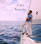 Couple embracing on a sailboat with 'Life's Beauty' text and product placement.