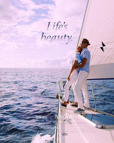 Couple embracing on a sailboat with 'Life's Beauty' text and product placement.