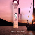Petra Living perfume bottle with a sailboat and sunset in the background