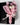 A small bouquet of dried white tulips wrapped in pink tissue paper and tied with a pale pink satin ribbon, presented inside an open black gift box on a light gray background.