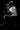Black and white photo of a couple embracing against a dark background