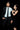 Man in a suit and woman in a dress posing against a black background