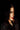 Woman with red lipstick wearing a sparkling outfit against a dark background