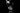 Two people in a dimly lit room with a mirror reflecting their image.