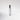 Clear glass 'Leather Noir' perfume bottle with silver cap on a light gray background