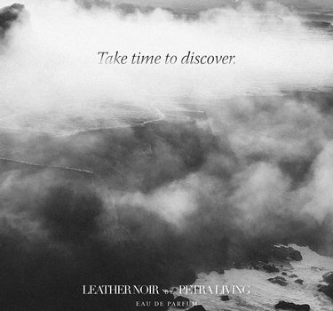 Black and white image of a mountain landscape with clouds and a quote about taking time to discover, with Petra Living branding.