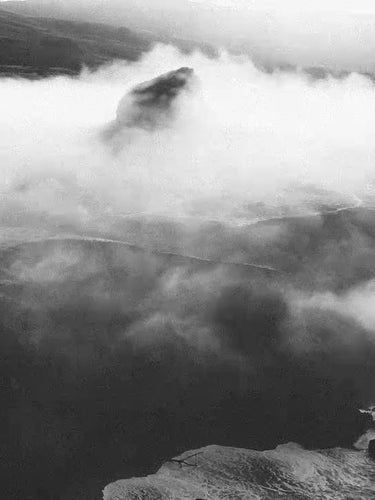 Mountain landscape with clouds partially covering the peaks