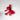 Red gift box en rouge with a large bow on a light gray background