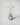 Parasol diffuser in antique glass green vase with white reeds and preserved flowers