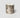 A cylindrical RICKHOUSE boubon scented candle in a metallic silver jar with a marbled, abstract pattern of dark gray and brown veins, set against a plain light gray background.