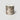 A cylindrical RICKHOUSE boubon scented candle in a metallic silver jar with a marbled, abstract pattern of dark gray and brown veins, set against a plain light gray background.