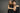 Man and woman posing closely against a gray background