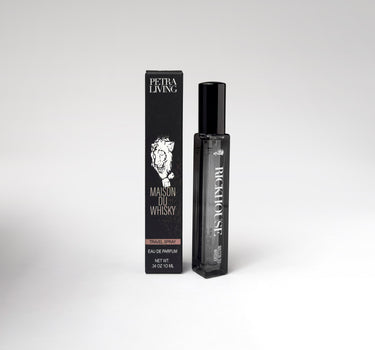 Perfume bottle and packaging with 'Petra Living' branding on a white background