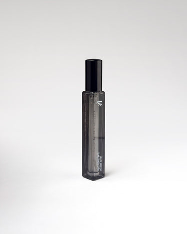Black perfume travel spray on white background