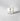 Clear candle in a glass container with a label on a gray background petite bougie votive