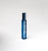 Blue perfume bottle with 'Trackside' branding on a white background