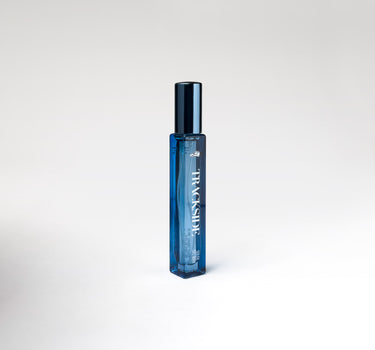 Blue perfume bottle with 'Trackside' branding on a white background