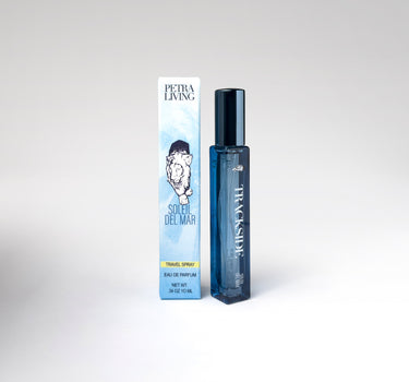 Perfume bottle and packaging with 'Trackside' branding on a white background