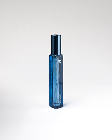 Blue perfume bottle on a white background
