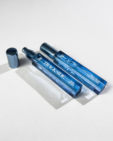 Blue spray bottle with 'Trackside' branding on a white background