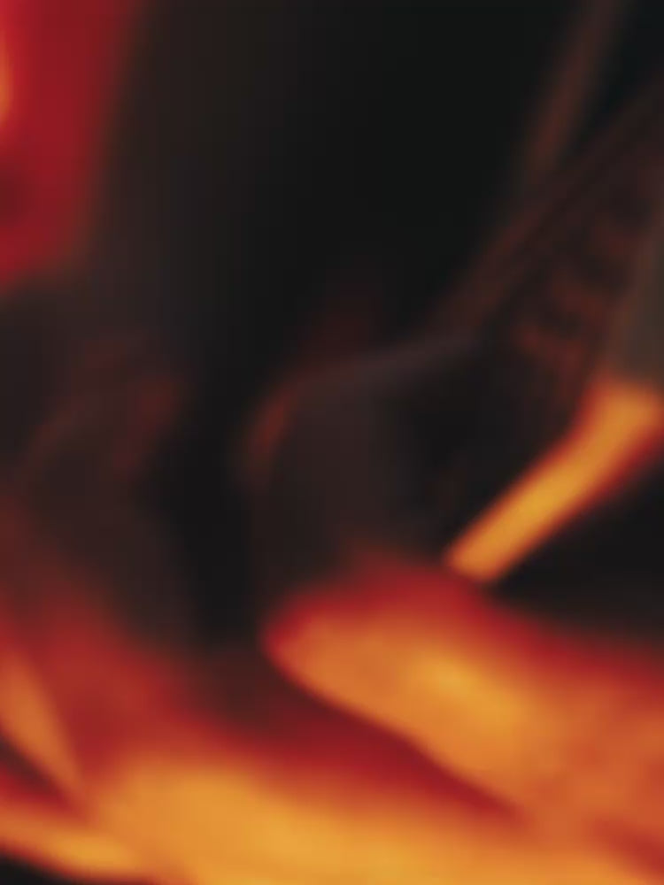 Two people embracing with a dark background